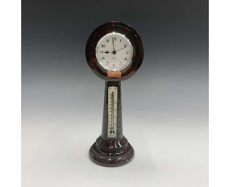 An early 20th century Cornish serpentine desk clock, the annular top inset a later clock movement, the pillar support with iv