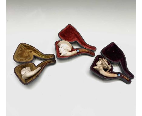 A 19th century meerschaum pipe, carved as the head of a lady, with a ribbon tied floral garland in her hair, cased, 14cm, tog