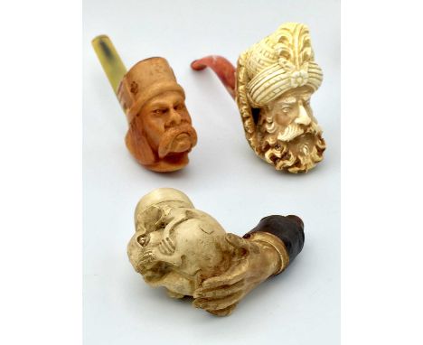 A modern resin pipe, decorated with the head of a Moor, cased, length 14cm, together with seven other resin pipes (8).