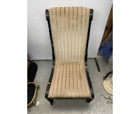 A Victorian Aesthetic Movement ebonised and gilt nursing chair with upholstered back and seat, and brass label for R. Garnett