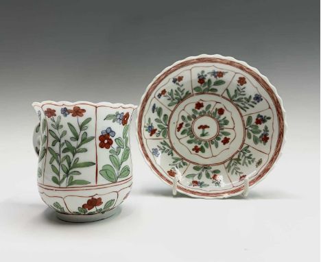 A rare Derby chocolate cup and saucer, circa 1760, with scalloped rims, the cup of bell shape, and with flattened pierced ear