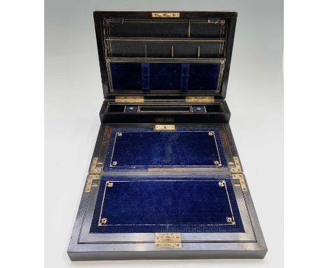 A remarkable Victorian well figured burr walnut trifold writing slope, with engraved brass mounts, opening to reveal a well a