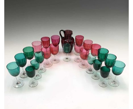 A group of 22 cranberry and green glass wines and sherry glasses, 19th century and an amethyst glass jug with Mary Gregory st