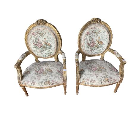 A pair of French giltwood and gesso armchairs, late 19th century, with a machine made tapestry upholstered back, arms and sea