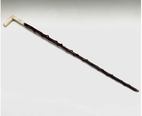 A 19th century ivory handled holly walking stick, with strapwork carved decoration.