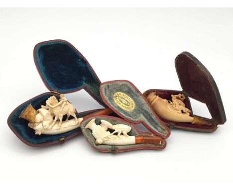 A Meerschaum pipe, 19th century, carved with a stag beetle, 9cm, cased, together with another of a boy riding a camel and ano