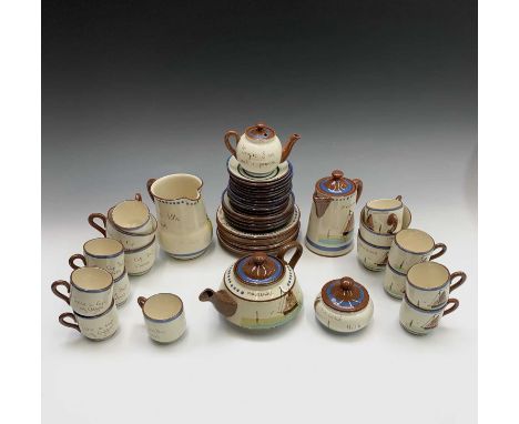 A Watcombe Torquay Mottoware pottery tea and coffee service, with boat decoration and inscribed 'Mousehole', comprising teapo