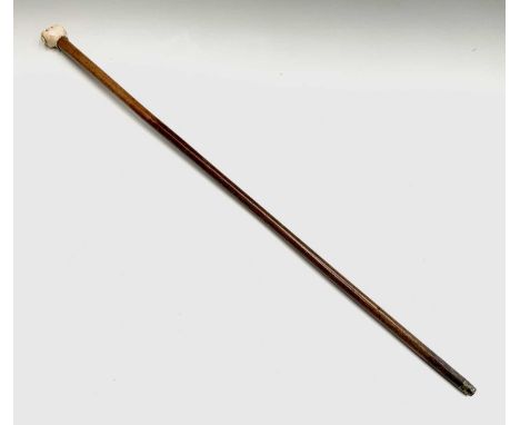 A 19th century nautical ivory and malacca walking stick, with clenched fist handle.