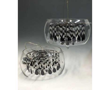 A pair of contemporary Dar lighting ceiling pendants, the clear globes with chrome supports enclosing three circles of hangin