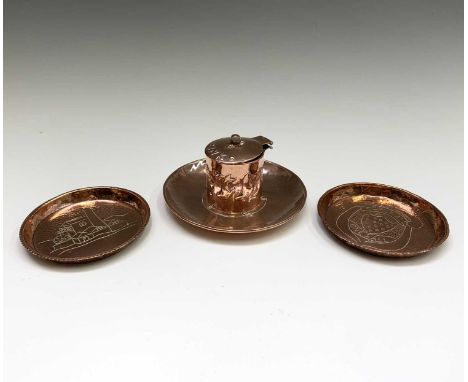 An Arts and Crafts copper inkwell, with hinged lid inscribed "Ink", the sides repousse decorated with stylised fish, diameter