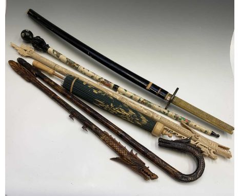 A Japanese sword, 20th century, with lacquered scabbard, length 101cm, together with a walking stick with carved dragon handl