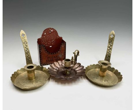A pair of brass Arts and Crafts chambersticks, circa 1900, each inscribed 'Good Night', together with a copper and brass cham