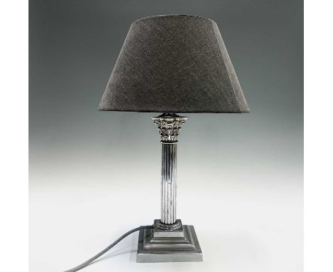 A plated Corinthian column table lamp base, with shade. Overall height 46.5cm.