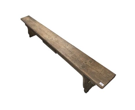 A pine bench or form, circa 1900, with solid shaped end supports, united by a stretcher, width 178cm.