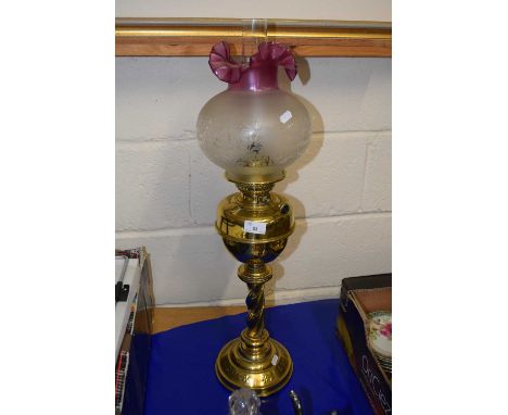 Brass based oil lamp with frosted tinted shade