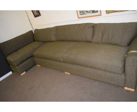 A large modern dark green corner sofa
