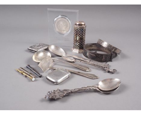 A silver pepperette with blue glass liner, two silver vesta cases, a silver spoon and pusher set, a silver bangle, four condi