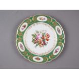 An early 19th century Continental porcelain dessert plate with reserved panels of flowers, on a