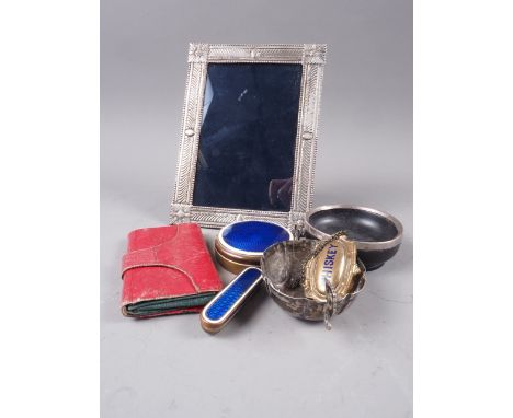 An Egyptian silver photograph frame, a silver mounted wooden dish, a white metal two-handled bowl, a brass and enamelled need