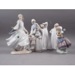 A Lladro figure of a seated woman with bird, 9 1/2" high, another similar figure of a young girl