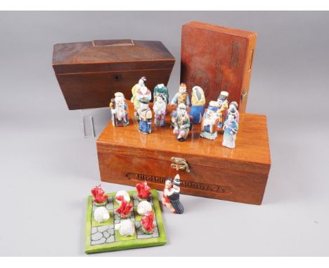 A mahogany sarcophagus two-division tea caddy, 10 1/2" wide, a mahogany desk tidy with pierced back, 11 1/2" high, an Orienta