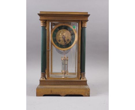 A 19th century gilt four-glass mantel clock, supported by four columns with green enamel and gilt dial with classical relief 