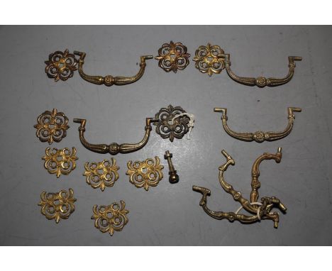 A set of four mid 18th century ormolu commode handles with floral cross back plates and a similar set of three handles 