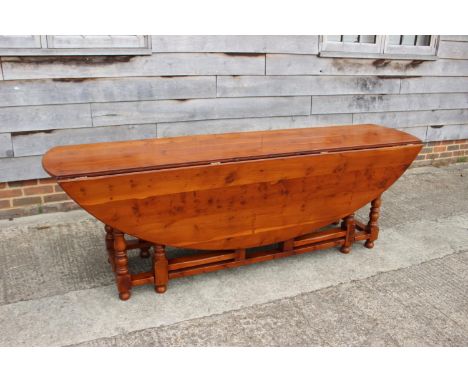 A yew wood wake table, on double gate leg turned and stretchered supports, top 90" x 58" x 29 1/2" high 