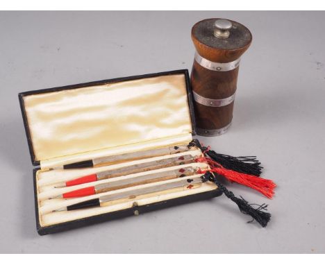 A set of four white metal bridge pencils, stamped sterling silver, in box, and a turned hardwood and silver banded pepper gri