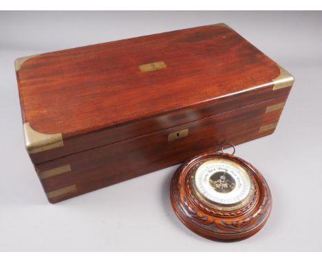 A mahogany and brass mounted writing slope with green leather interior, 19 3/4" wide, and a circular carved oak barometer, 7 