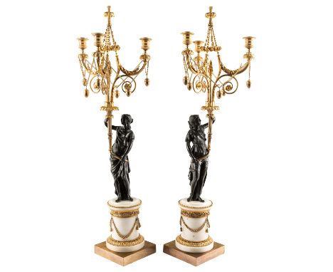 A PAIR OF LATE EMPIRE HARDSTONE AND ORMOLU-MOUNTED CANDELABRA, EARLY 19TH CENTURY the black-patinated bronze bodies modelled 