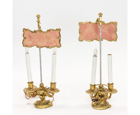 A PAIR OF BEDSIDE ORMOLU BRONZE CANDELABRA, EARLY 20TH CENTURY the two-light candelabra on rocaille bases, with screens, elec