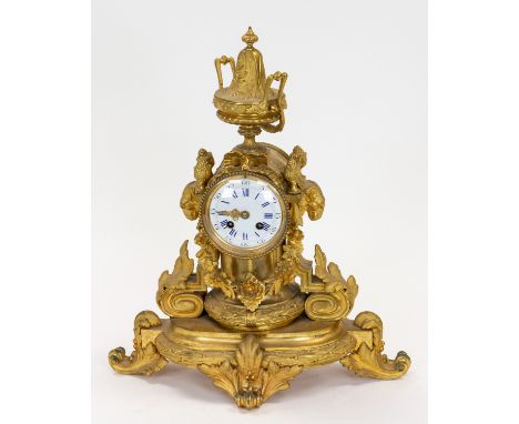 A EUROPEAN GILT BRONZE CLOCK, LATE 19TH CENTURY the clock with enamel dial with suspending flower garland, flanked by ram hea
