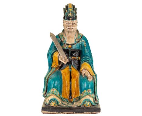 A MONUMENTAL SANCAI-GLAZED FIGURE OF A JUDGE, MING DYNASTY the judge with a severe expression, holding a tablet in his right 