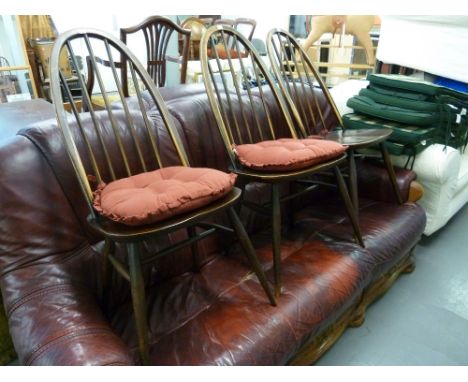 A SET OF THREE ERCOL HARDWOOD HOOP BACKED SINGLE CHAIRS, WITH PANEL SEATS 