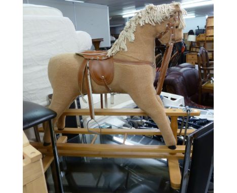 CHILD'S MODERN ROCKING HORSE,  WOODEN WITH FAWN NYLON COAT, COTTON MANE, LEATHER CLOTH SADDLE AND TACK, SWINGING ON A LIGHT B