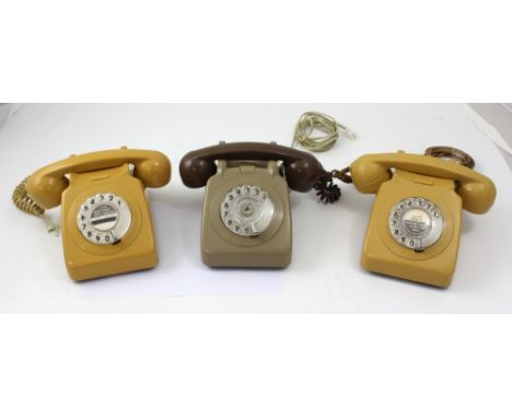 Three c1975 GPO telephones, two in mustard and one in a grey and brown finish (3).