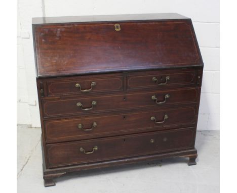 A George III mahogany line inlaid bureau with architectural fitted interior to include two pilaster column hidden columns ove