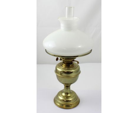 A 20th century brass oil lamp with opaque white glass shade, height 53cm.