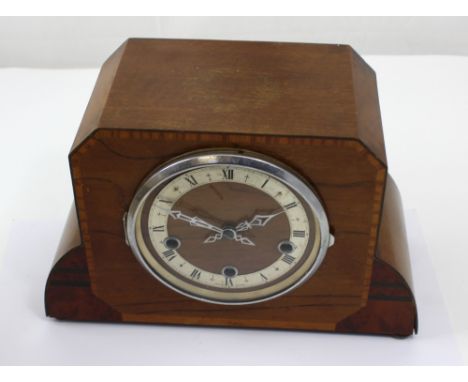 A c1950s oak cased Art Deco style eight day mantel clock the wooden and silvered dial set with Roman numerals, height 23cm.