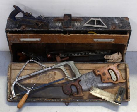 A black vintage wooden toolbox containing vintage planes, various other vintage tools, a Dision saw etc.