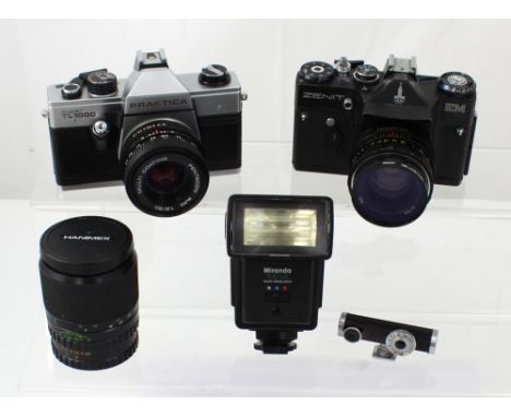 A Zenit 35mm camera body with Helios 52mm lens, a Miranda flash gun, a Practika Super TL1000 35mm camera body with 50mm lens,