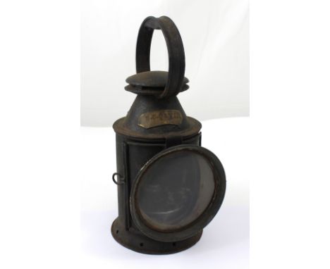 A 19th century black painted railwaymen's lamp with revolving coloured glass insert and marked 'H J Davies' to the copper pla