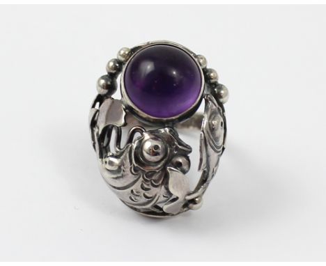 Niels Erik From (Danish 1908-1982); a sterling silver and amethyst cabochon mounted aquarium ring decorated with fish and air