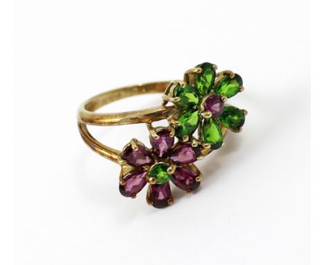 A 9ct gold ladies' dress ring, floral-set with two flowers, one with purple stones and green central stone, the other with gr