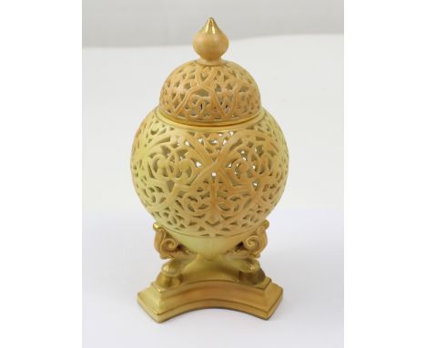 A Grangers Worcester peach blush reticulated vase and cover of obovoid form on three leg platform base, marked 'Royal China W