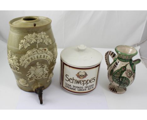 A late 19th early 20th century stoneware whiskey barrel with raised relief decoration of knights, lions head masks, grapes an