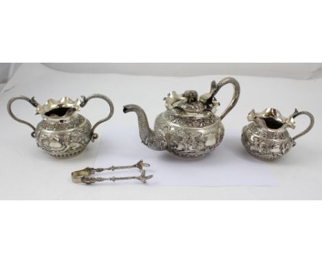 An early 20th century Indian white metal three piece tea service comprising teapot, sucre, and milk jug, and a matching pair 