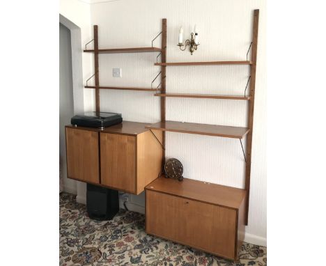 A 1960s G-Plan style teak wall mounted shelf and cabinet unit.