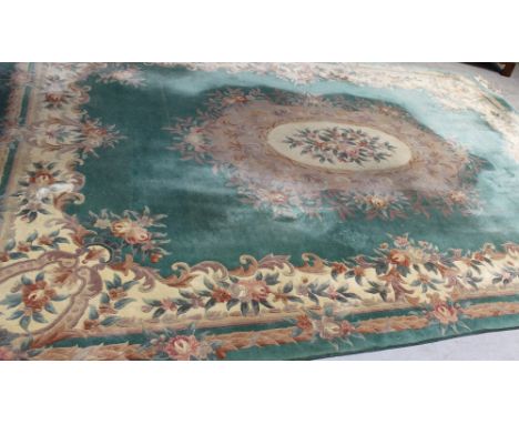 A very large Chinese washed wool pale jade green ground carpet with apricot cream and taupe floral decoration, approx 360 x 2